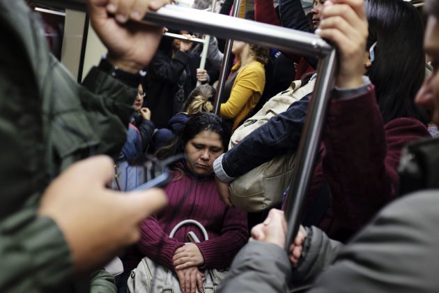 Commuters ride a subway train during rush hour in downtown Sao Paulo