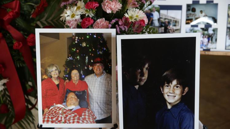 In this Friday, Jan. 10, 2014 photo, a picture of 7-year-old Mikey Cortez, right, and a recent photo of Cortez with his parents, Paul and Roonie Cortez, and grandmother Nellie are displayed at a funeral service during a funeral service for Mikey Cortez in Murietta, Calif. As his 7-year-old son Mikey lay in a hospital bed on life support, the victim of a drunk driver who had smashed into the car he was riding in, Paul Cortez took the boy&#39;s hand and made a solemn promise to God: If his son survived, no matter in what condition, he and his family would always be there for him. Although he would never emerge from the persistent vegetative state his father had found him in that night, Mikey’s family was not only there for him but also gave him a full life. A life, as it turned out, not all that different from anybody else’s, with cross-country family vacations and visits to Disneyland. (AP Photo/Jae C. Hong)