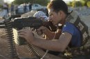 Syrian rebel fighters take part in target practice in Daraya