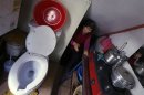 Kong walks after washing her hands through a space that consists of a toilet, bathroom and kitchenette in her rented apartment in Seocho-gu