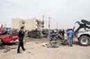 Police examine the wreckage after a car bomb exploded in Basra, 420 km (261 miles) southeast of Baghdad