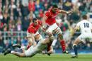 England's James Haskell, left, tackles Wales' Taulupe Faletau during the Six Nations international rugby match between England and Wales at Twickenham stadium in London, Saturday, March,12, 2016. (AP Photo/Alastair Grant)