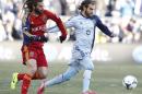 Real Salt Lake midfielder Kyle Beckerman, left, and Sporting Kansas City forward Graham Zusi, right, battle for the ball during the first half of the MLS Cup final soccer match in Kansas City, Kan., Saturday, Dec. 7, 2013. (AP Photo/Colin E. Braley)