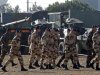 French soldiers, who prepare for their departure for Mali, walk past armoured vehicles at the military base of Miramas