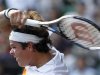 Raonic of Canada follows through on a shot against Murray of Britain at the men's singles semi-finals match at the Japan Open tennis championships in Tokyo