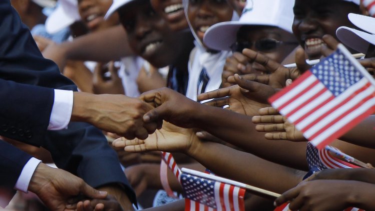 U.S. President Barack Obama shakes hands and greets Tanzanians during an official arrival ceremony in Dar Es Salaam
