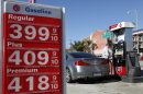 A man buys gas at a station Thursday Jan. 31, 2013 in Los Angeles. Gasoline prices are climbing as rising economic growth boosts oil prices and temporary refinery outages crimp gasoline supplies on the East and West Coasts. (AP Photo/Nick Ut)