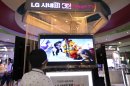 A boy watches a 3D animation movie at a display for LG Electronics products inside the COEX Mall in Seoul, South Korea, Wednesday, July 25, 2012. LG Electronics reported a lower quarterly profit as its mobile phone division sank to a loss, underlining the challenges for its smartphone business as it struggles with competition from Apple and Samsung. (AP Photo/Hye Soo Nah)