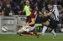 Roma's Kostas Manolas, left, and Juventus' Carlos Tevez fight for the ball during the Serie A soccer match between Roma and Juventus at Rome's Olympic stadium, Monday, March. 2, 2015. (AP Photo/Gregorio Borgia)