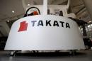 A logo of Takata Corp is seen with its display at a showroom for vehicles in Tokyo