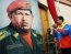 Venezuelan Vice President Nicolas Maduro (R) looks at a portrait of Venezuelan President Hugo Chavez on February 4, 2013