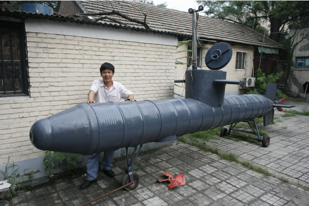 Tao Xiangli stands beside his self-made submarine in a courtyard in Beijing