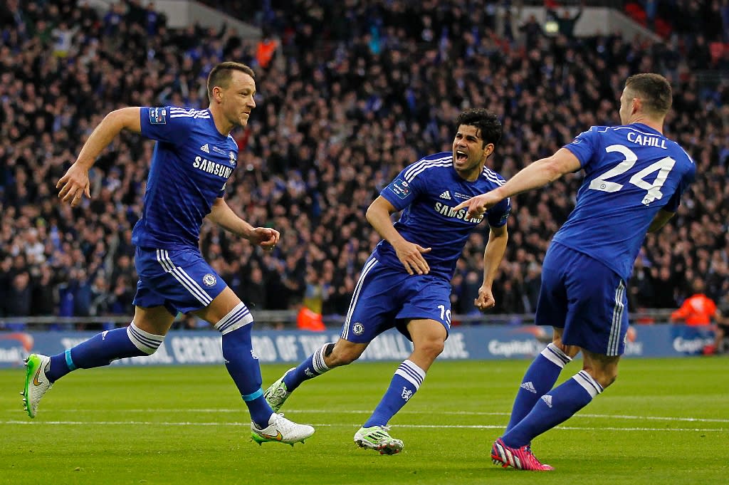 Chelsea's John Terry (L) celebrates scoring the opening goal with teammates Diego Costa (C) and Gary Cahill during their English League Cup final match against Tottenham Hotspur, at Wembley Stadium in London, on March 1, 2015