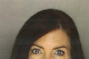 In this Saturday, Aug. 8, 2015 photo provided by the Montgomery County District Attorney's Office, Pennsylvania Attorney General Kathleen Kane appears in a booking mug taken in Norristown, Pa. Kane, the state's first elected female attorney general, vows to fight perjury, obstruction and other charges for allegedly leaking secret grand jury material to embarrass rivals and then lying about it under oath. (Montgomery County District Attorney's Office via AP)