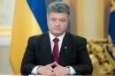 Handout picture taken and released by Ukrainian presidential press service on June 21, 2014 shows Ukrainian President Petro Poroshenko (C) during his broadcast address to the nation