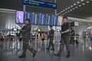 Soldiers patrol through a terminal at Paris Charles de Gaulle airport in Roissy, France, Friday, July 4, 2014. The French civil aviation authority on Friday announced stepped-up security measures 