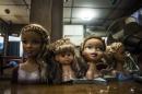 This June 12, 2015 photo shows hair styling doll heads on a counter at a hair salon in downtown San Salvador, El Salvador. Salvadoran women are giving up their blonde hair and highlights and dying it all black out of fear. The word on the street is that only the girlfriends of gang members are allowed to be redheads or blondes. Women who defy the order could be attacked. There's no evidence the rumors are true. (AP Photo/Manu Brabo)