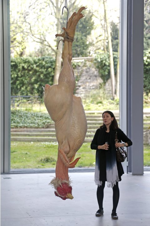 A visitor looks at a sculpture entitled "Still Life"  by artist Ron Mueck during his exhibition at the Fondation Cartier pour l'art contemporain in Paris