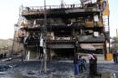 People gather at the site of a bomb attack in Baghdad's Karrada district