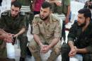 Zahran Alloush, commander of Jaysh al Islam, sits during a conference in the town of Douma, eastern Ghouta in Damascus