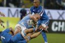 Argentina's Facundo Isa, center, competes for the ball with Italy's Simone Favero, bottom left, and Italy's Kelly Haimona during an international rugby union test match, at the Luigi Ferraris stadium in Genoa, Friday, Nov. 14, 2014. (AP Photo/Antonio Calanni)