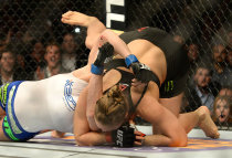 Ronda Rousey works for a submission on Saturday. (USAT)