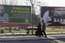 Pedestrians pass by a billboard with a picture of imprisoned Kurdish rebel leader Abdullah Ocalan in Diyarbakir