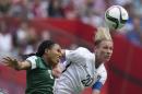 FILE - In this June 16, 2015, file photo, Nigeria's Onome Ebi, left, and United States' Abby Wambach vie for the ball during a FIFA Women's World Cup soccer game in Vancouver, British Columbia, Canada. With the title match looming, Wambach isn't mincing words. "All I care about is winning this World Cup," she said. The star U.S. forward is playing in her fourth Women's World Cup, and she says it will be her last. A victory Sunday, July 5, in the final against Japan would be the perfect ending to her World Cup career. (Darryl Dyck/The Canadian Press via AP, File)