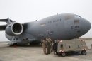 A French airman, center, talks to British military personnel prior to the take off a British C17 transport plane enroute to Mali at the French army base in Evreux, 90 kms(56 mls)north of Paris, Monday, Jan. 14, 2013. British military equipment was readied for deployment in Mali on Monday as international intervention in the country increased following advances in the north by Islamic extremists with reported links to Al-Qaida. Two C-17 transport planes have arrived at the French military airbase at Evreux, bound for Mali. Two C-17 transport planes have arrived at the French military airbase at Evreux, bound for Mali. (AP Photo/Michel Euler)