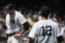 New York Yankees' Eric Chavez (12) approaches the pitchers mound as starting pitcher Andy Pettitte grimaces during the fifth inning of a baseball game against the Cleveland Indians Wednesday, June 27, 2012, in New York. (AP Photo/Frank Franklin II)