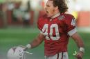 ADVANCE FOR WEEKEND EDITIONS APRIL 30-MAY 1 - FILE - In this Dec. 20, 1998, file photo, Arizona Cardinals safety Pat Tillman celebrates after tackling New Orleans Saints running back Lamar Smith for a loss in the third quarter of an NFL football game in Tempe, Ariz. Pat Tillman became an inspiration when he walked away from a lucrative NFL career to fight for his country after the Sept. 11 terrorist attacks, a decision that ultimately cost the football star turned soldier his life. Now Tillman's legacy lives on through the parents who have named their children after him. (AP Photo/Roy Dabner, File)