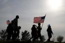 People participate in a flag walk in memory of those killed and injured by Iraq war veteran, Ivan Lopez, on April 4, 2014, in Killeen, Texas