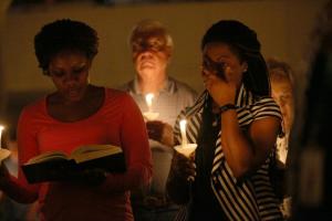 People hold candles during a a prayer vigil and memorial&nbsp;&hellip;