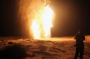 An Egyptian stands in front of a gas pipeline that was blown up by attackers in Al-Arish, on July 22, 2012