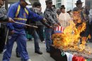 Supporters of Bolivia's President Morales burn a head mask of U.S. President Obama during a protest in La Paz