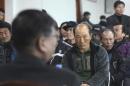 In this Feb. 19, 2014 photo, a government official, foreground, meets with salt farm owners and workers as a part of human rights inspection on Sinui Island, South Korea. Life as a salt-farm slave was so bad Kim Jong-seok sometimes fantasized about killing the owner who beat him daily. Freedom, he says, has been worse. In the year since police emancipated the severely mentally disabled man from the farm where he had worked for eight years, Kim has lived in a grim homeless shelter, preyed upon and robbed by other residents. He has no friends, no job training prospects or counseling, and feels confined and deeply bored. (AP Photo/Ahn Young-joon)