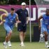 France's soccer players Giroud and Malouda run in front of coach Blanc during a training session at the team's training center in Kircha near Donetsk