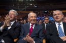 Israeli President Shimon Peres , center, sits flanked by former US President Bill Clinton and Israeli Prime Minister Benjamin Netanyahu, right, in a Jerusalem convention center as Peres' 90th birthday gala gets underway, Tuesday June 18 2013. (AP Photo/ Jim Hollander, pool)
