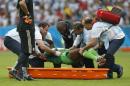 Nigeria's Michael Babatunde is lifted from the pitch before being taken off the field during the group F World Cup soccer match against Argentina at the Estadio Beira-Rio in Porto Alegre, Brazil, Wednesday, June 25, 2014. (AP Photo/Jon Super)