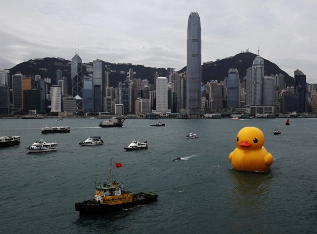 Rubber Duck by Dutch artist Hofman is pulled by tugboat at Hong Kong's Victoria Harbour