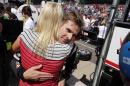 Will Power, of Australia, hugs his wife, Elizabeth, after finishing the 99th running of the Indianapolis 500 auto race at Indianapolis Motor Speedway in Indianapolis, Sunday, May 24, 2015. (AP Photo/Sam Riche)
