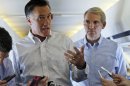 Republican presidential candidate and former Massachusetts Gov. Mitt Romney speaks to reporters on his campaign plane en route to Denver, Sunday, Sept. 23, 2012, as Sen. Rob Portman, R-Ohio, listens at right. (AP Photo/Charles Dharapak)