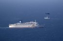 An Israeli military naval ship and an Israeli air force helicopter operate next to a cruise ship off the coast of Haifa, northern Israel, Thursday, April 25, 2013. Israel shot down a drone Thursday as it approached the country's northern coast, the military said. Suspicion immediately fell on the Hezbollah militant group in Lebanon. The incident was likely to raise already heightened tensions between Israel and Hezbollah, a bitter enemy that battled Israel to a stalemate during a monthlong war in 2006. (AP Photo/Ariel Schalit)