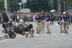 Indonesian policemen collect evidence on a road following&nbsp;&hellip;
