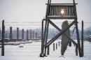 A watch tower along a barbed wire fence at the memorial site of the former Auschwitz-Birkenau concentration camp is pictured on January 26, 2015