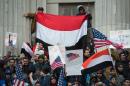 People rally with flags at Brooklyn Borough Hall as Yemeni bodega and grocery-stores shut down to protest US President Donald Trump's Executive Order banning immigrants and refugees from seven Muslim-majority countries on February 2, 2017 in New York