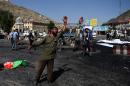 An Afghan protester screams near the scene of a suicide attack that targeted crowds of minority Shiite Hazaras during a demonstration in Kabul on July 23, 2016