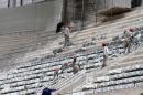 FILE - In this Jan. 21, 2014 file photo released by Portal da Copa, workers install seats at the Arena da Baixada stadium in Curitiba, Brazil. The southern city of Curitiba is expected to remain in the World Cup despite construction delays on its stadium, Brazilian Sports Minister Aldo Rebelo said Wednesday, Feb. 5, 2014. During a visit to the city, he expressed confidence that local organizers will be able to show FIFA that the stadium will be ready in time to hold its four matches scheduled for football's showcase event in June. (AP Photo/Portal da Copa, Paulino Menezes, File)