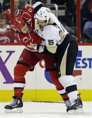 Carolina Hurricanes' Kevin Westgarth (8) and Pittsburgh Penguins' Deryk Engelland (5) fight during the first period of an NHL hockey game in Raleigh, N.C., Tuesday, April 9, 2013. (AP Photo/Gerry Broome)