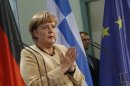 German Chancellor Merkel gestures during news conference after talks with Greek Prime Minister Samaras at Chancellery in Berlin